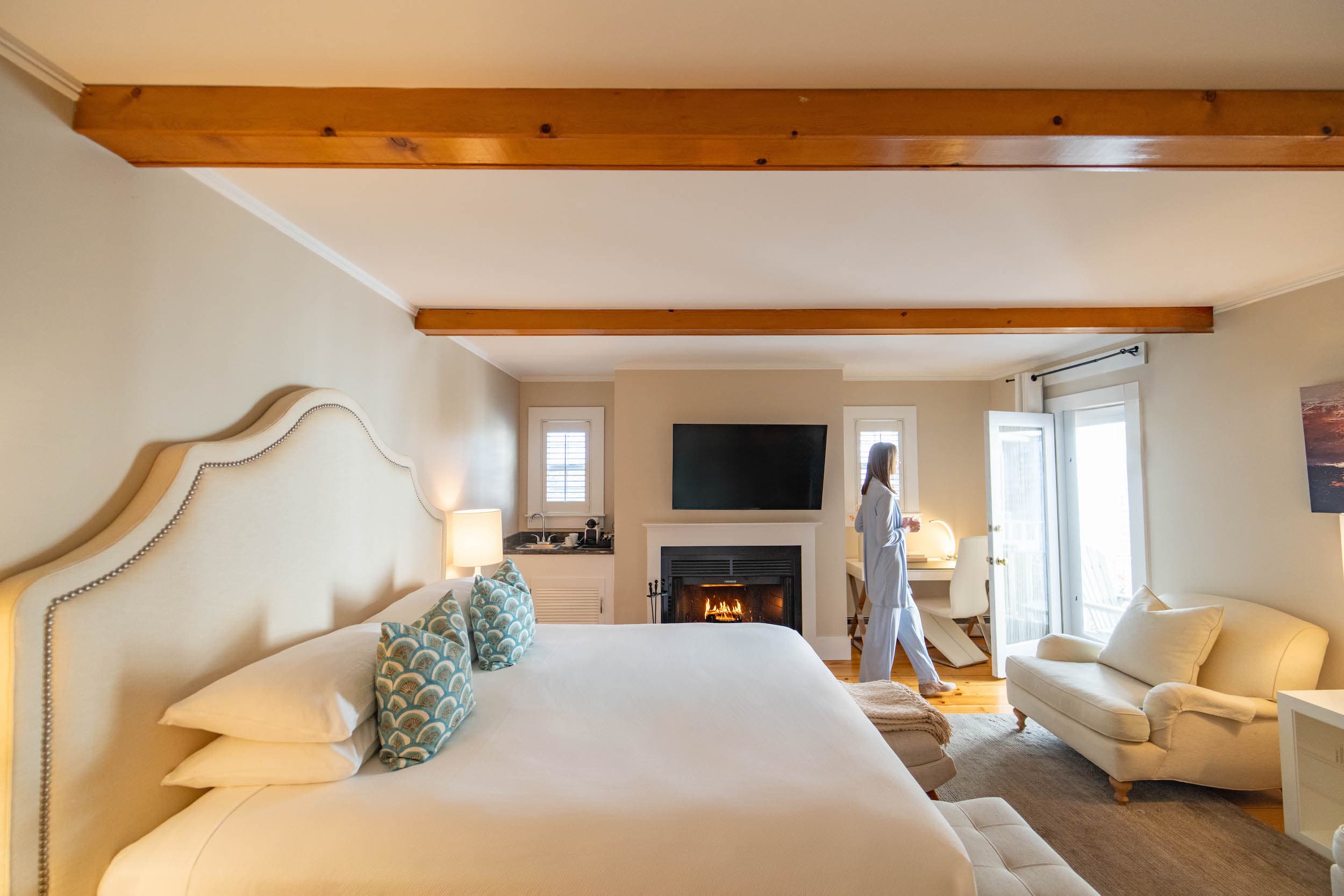 A woman in a spacious room at Chatham drinking coffee