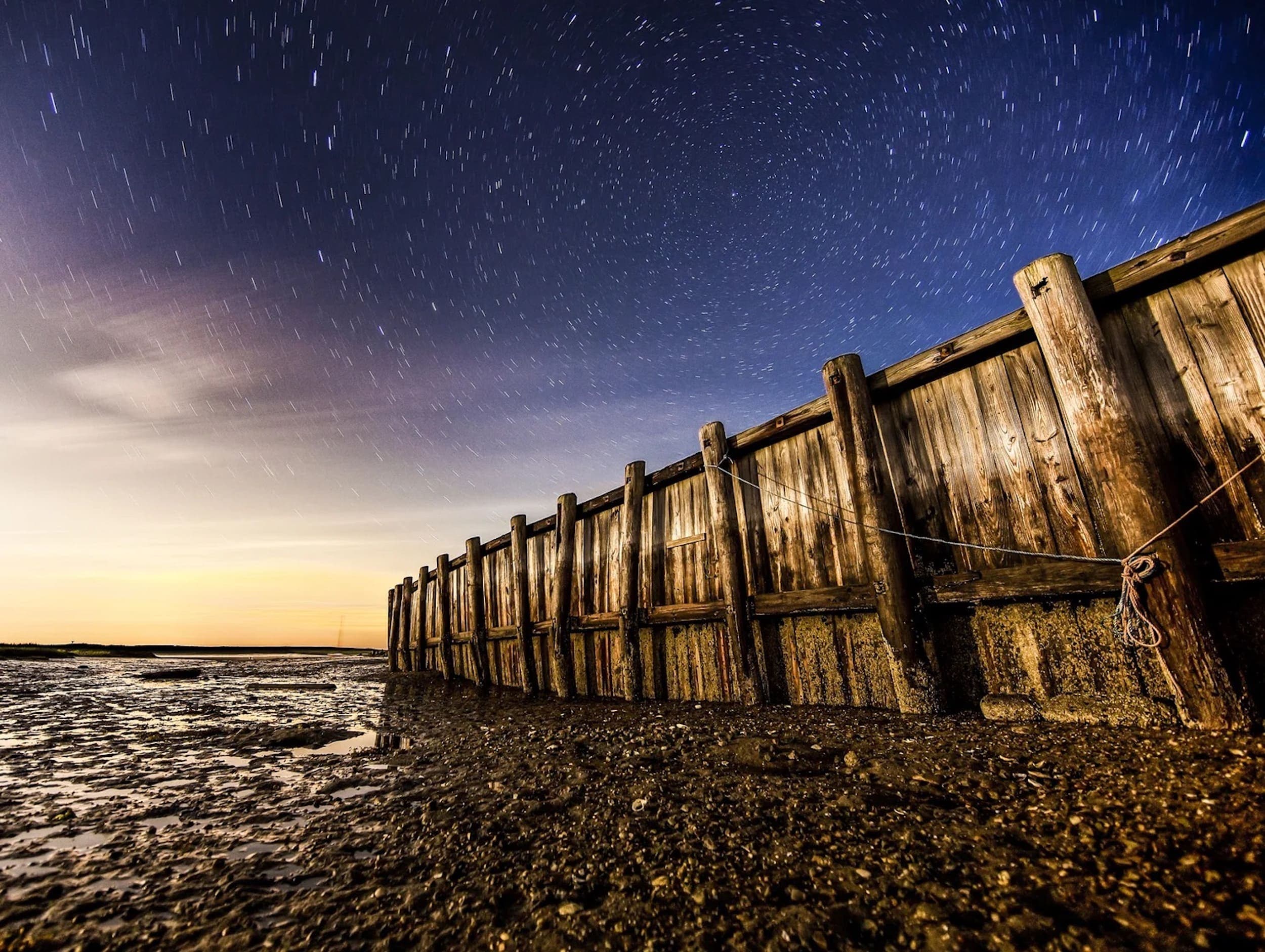 A photograph of the shoreline and a dock taken by artist Paul Blackmore