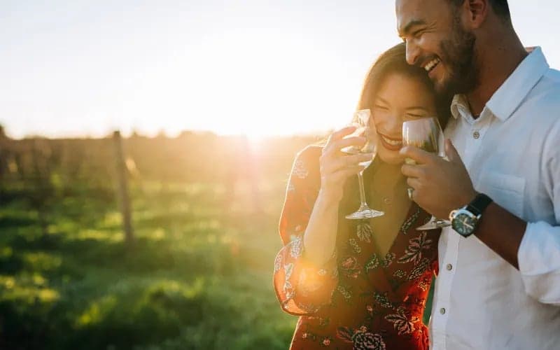 A couple embracing at a Cape Cod Wine Tasting in the vineyard