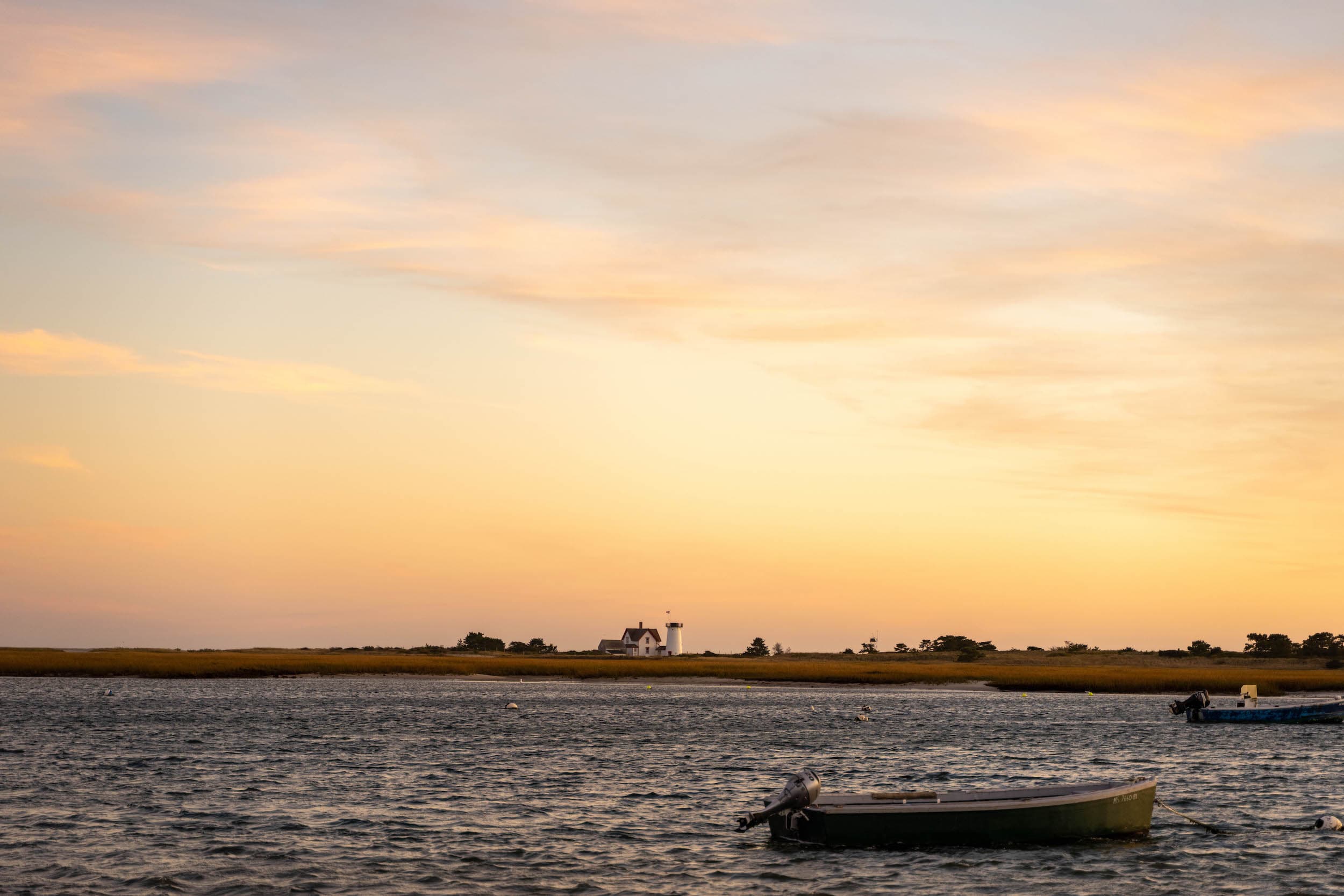 a few fishing boats in the water at sunset near Chatham Inn
