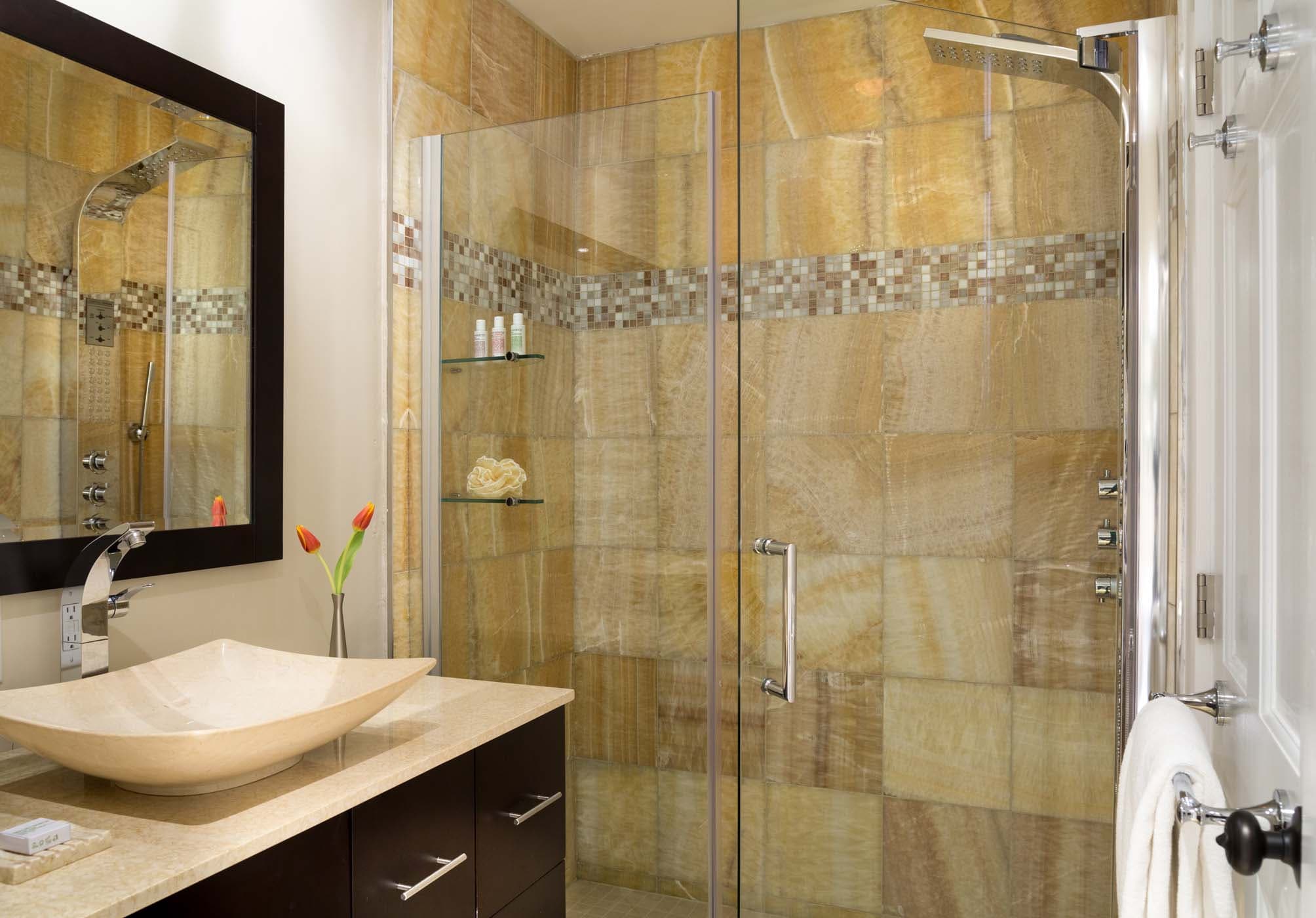 The shower and vanity with 2 tulips in room 12 at Chatham Inn