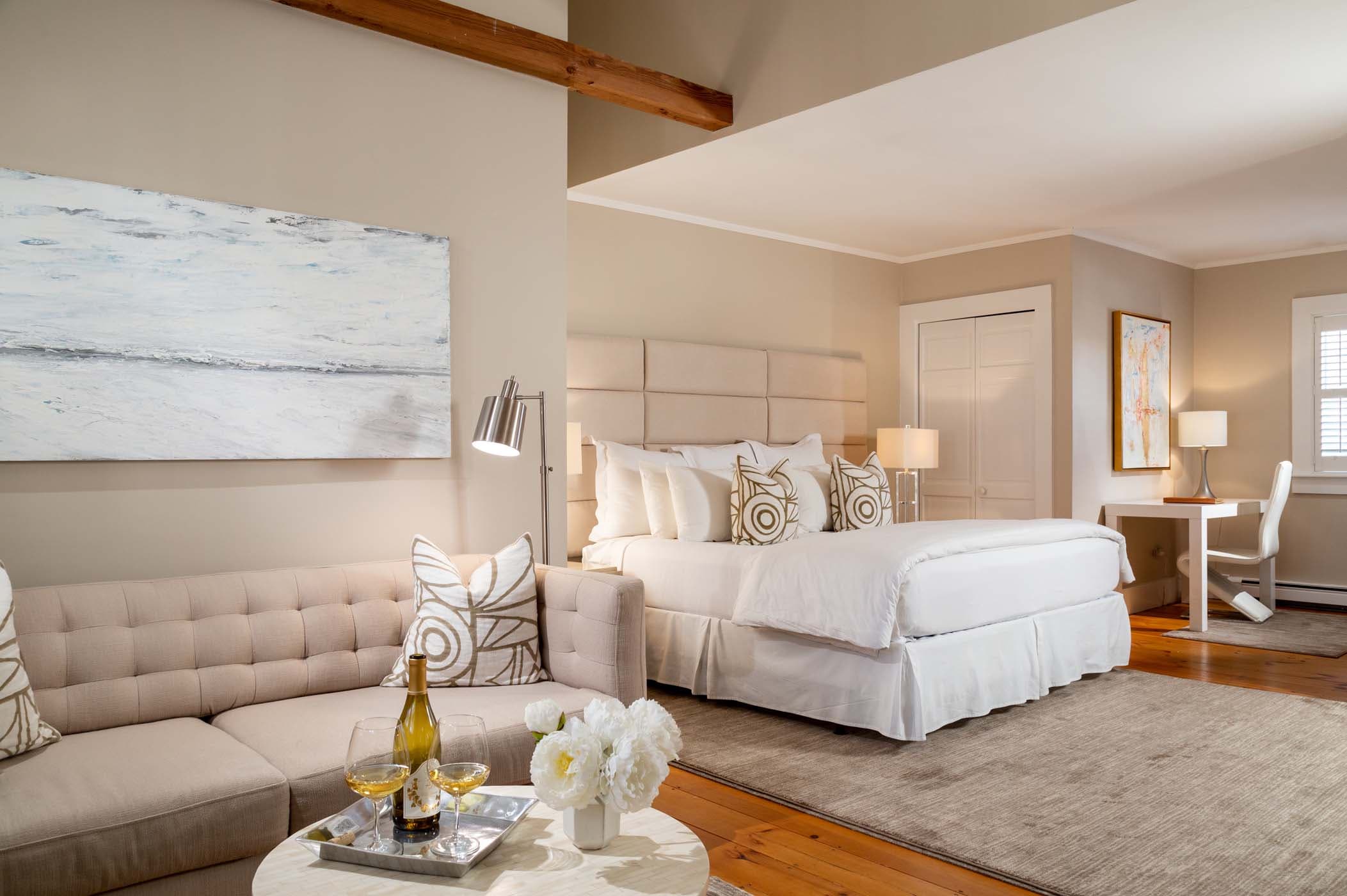 A large bed, desk, and living space in a room at Chatham Inn