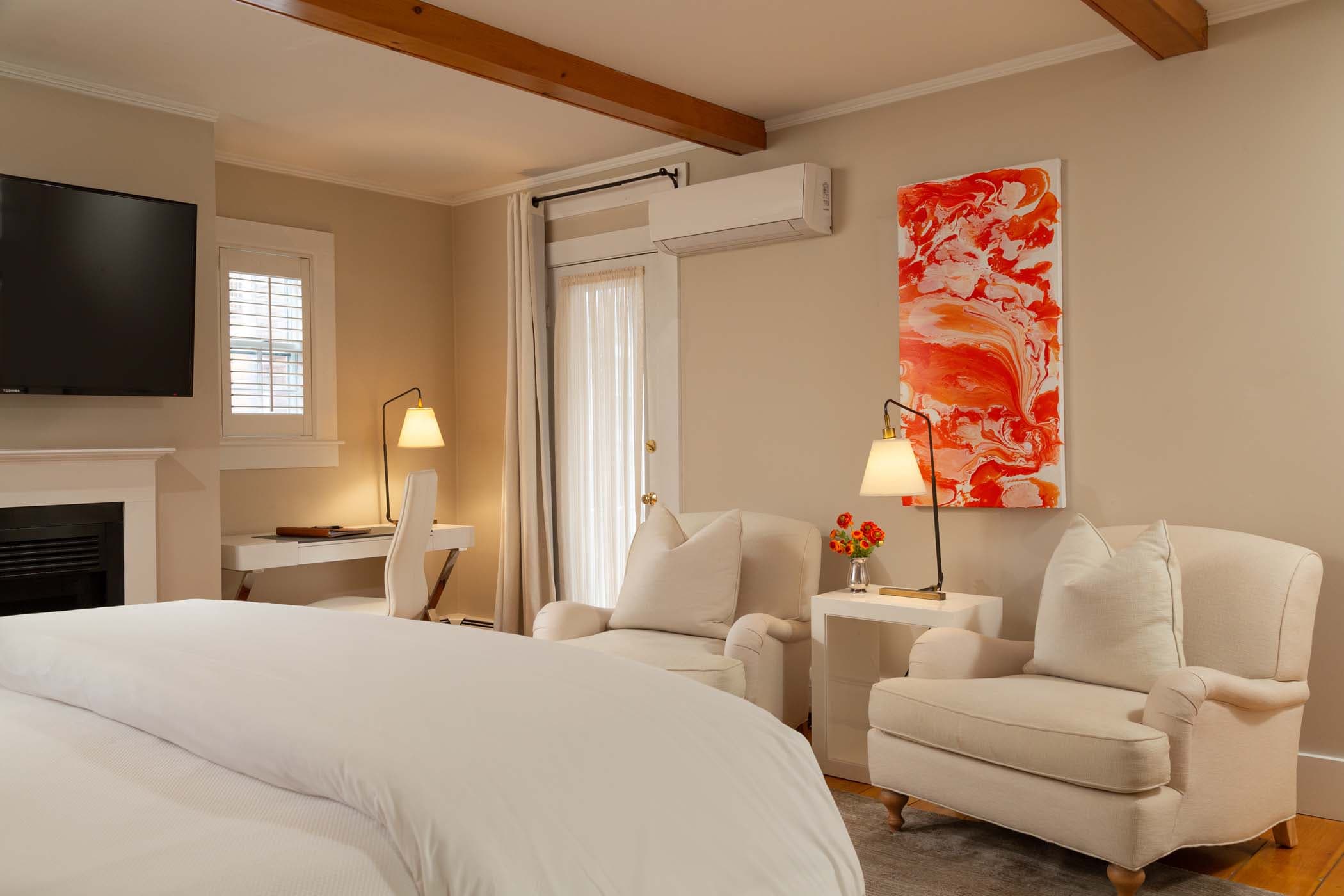 An elegant Room 2 in Chatham Inn with gorgeous wall art and a cozy sitting area