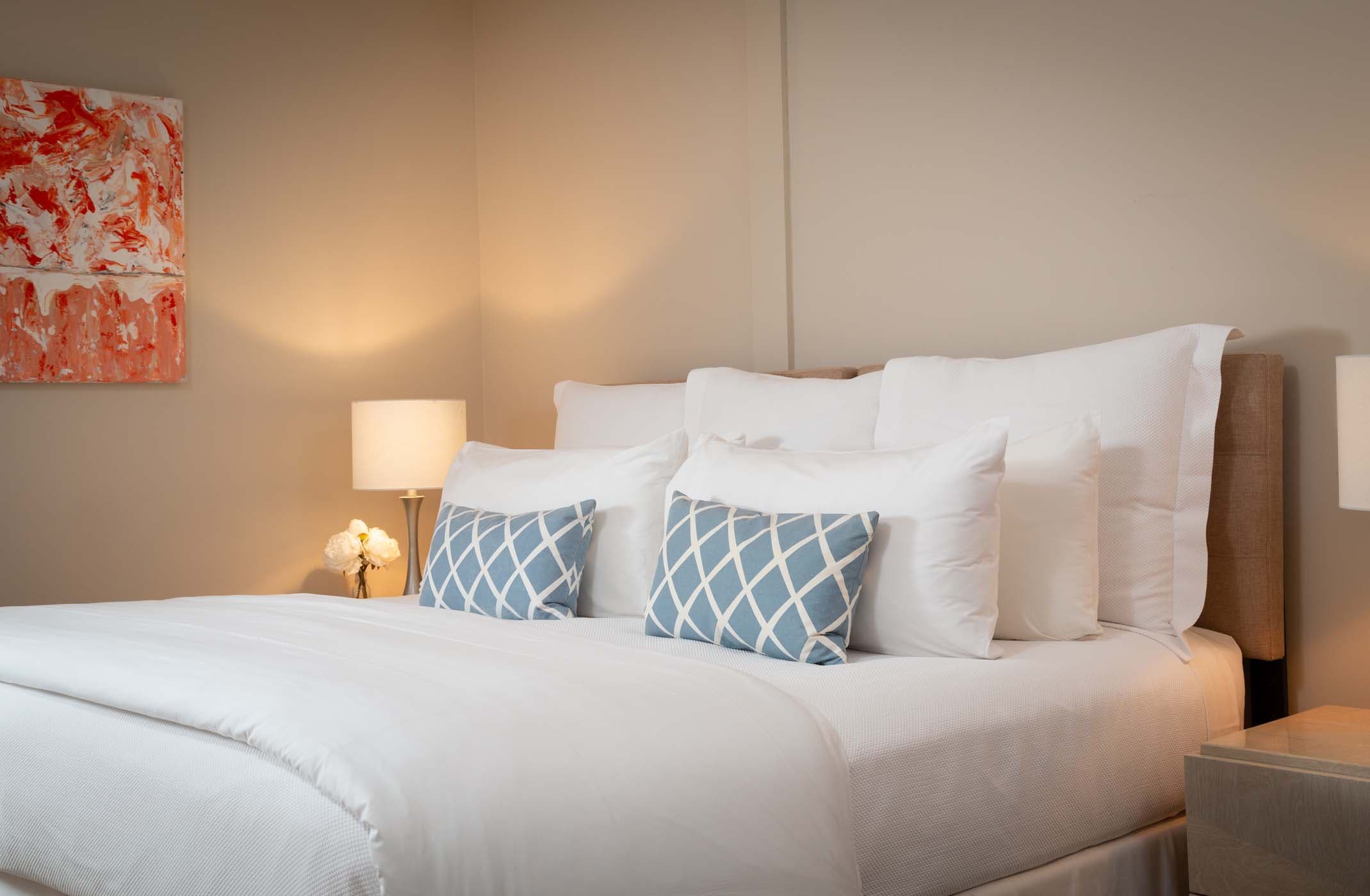 A queen bed in Room 6 with gorgeous wall art at Chatham Inn