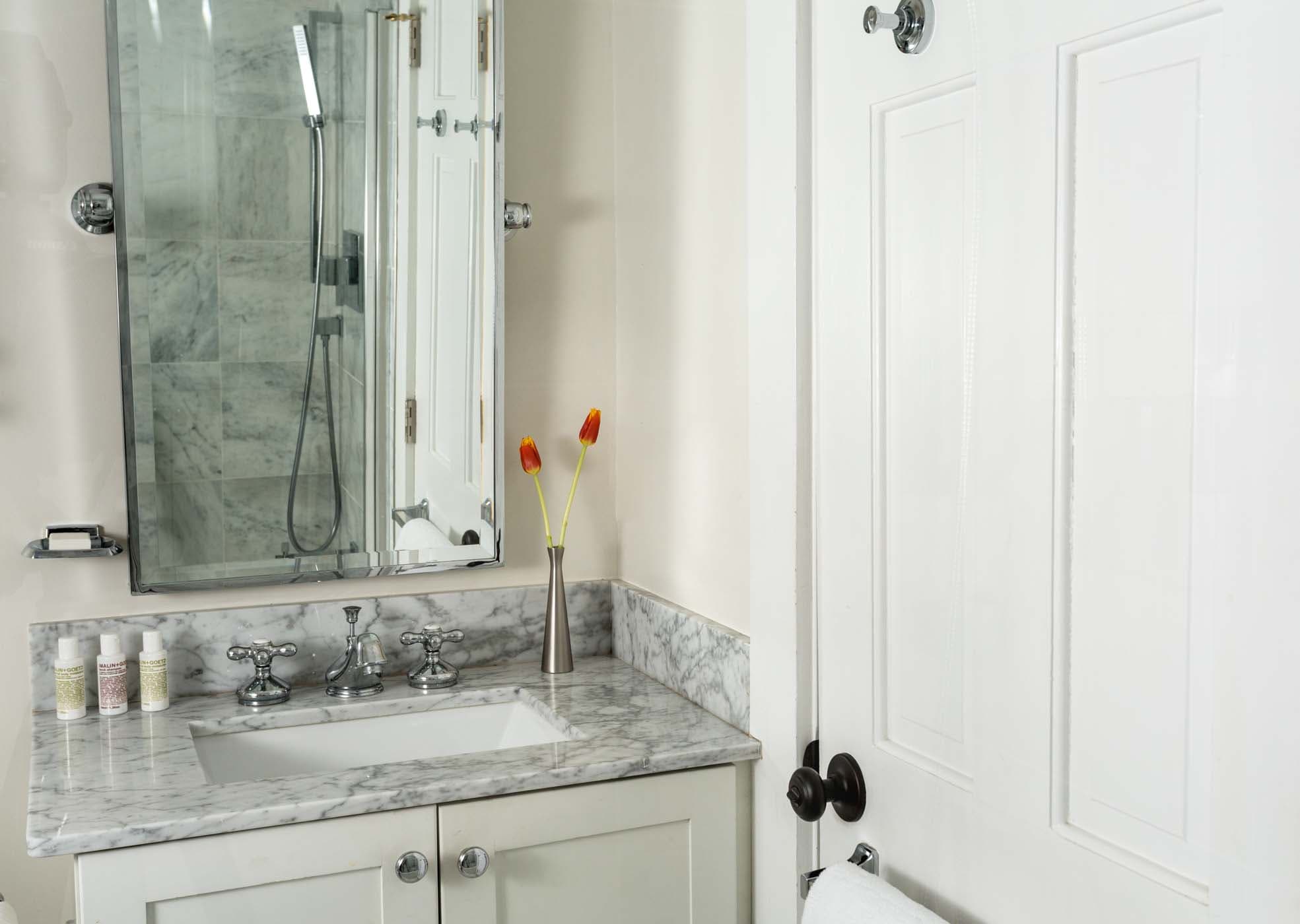 A spacious room 9 bathroom with flowers at Chatham Inn