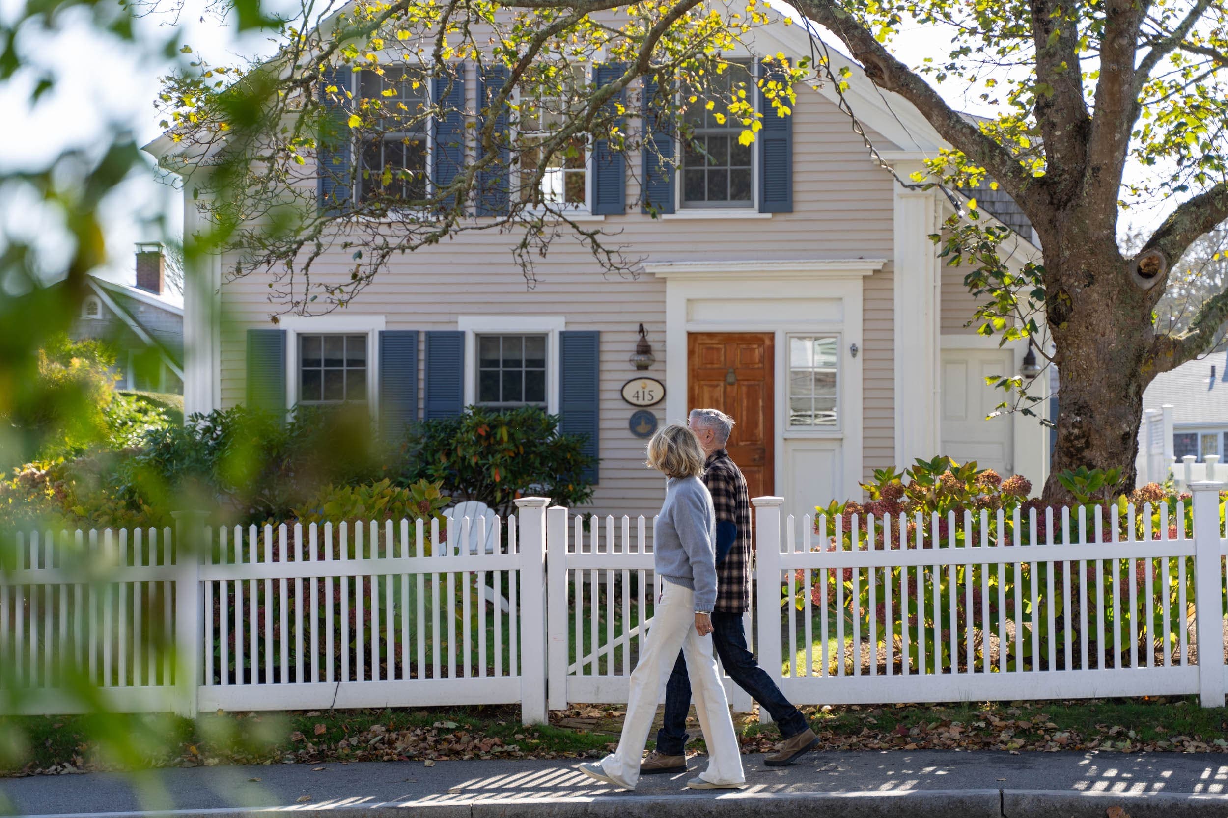 A couple walking down the street near the Chatham Inn