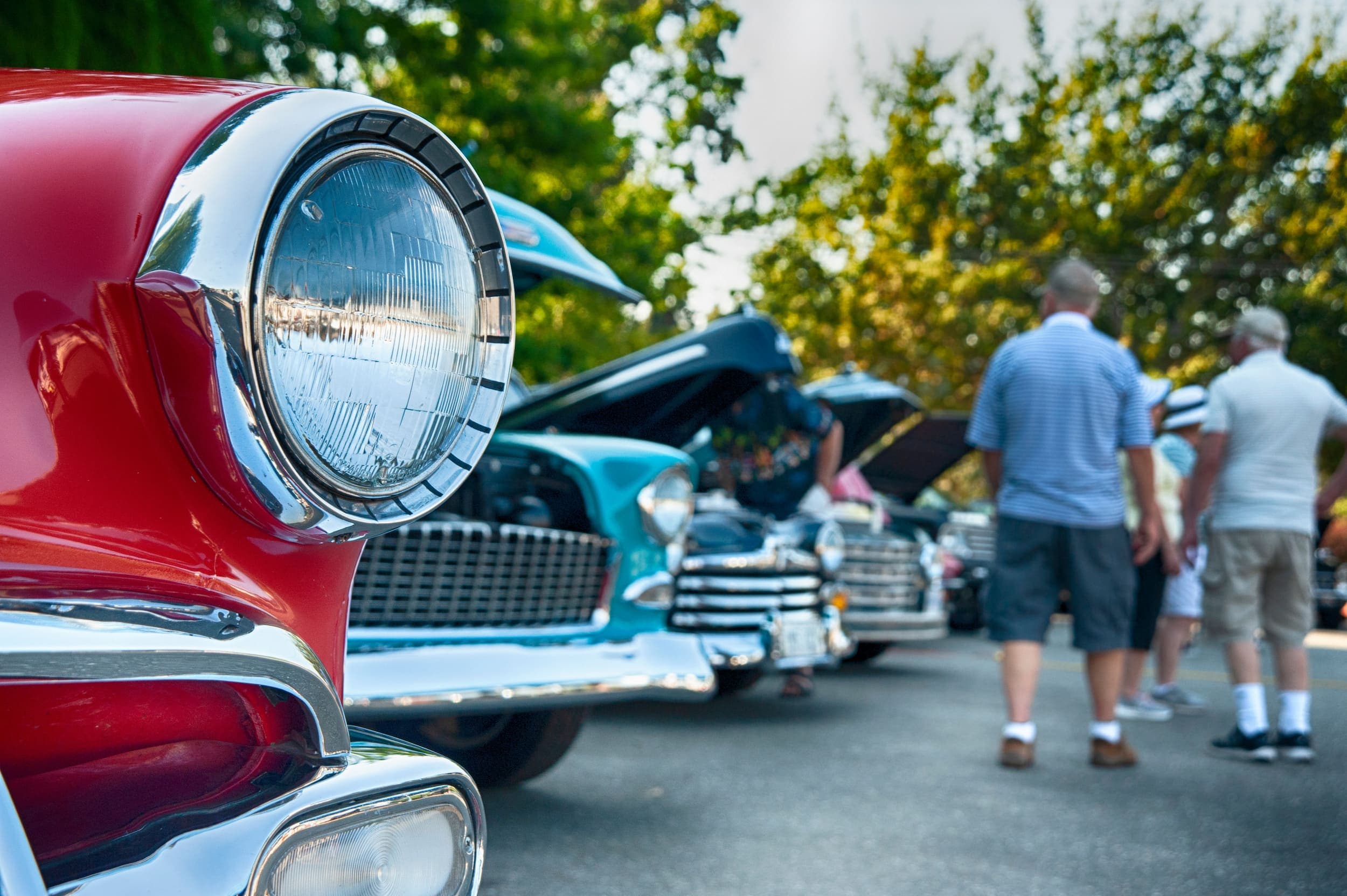 A bunch of vintage cars lined up at an auto show