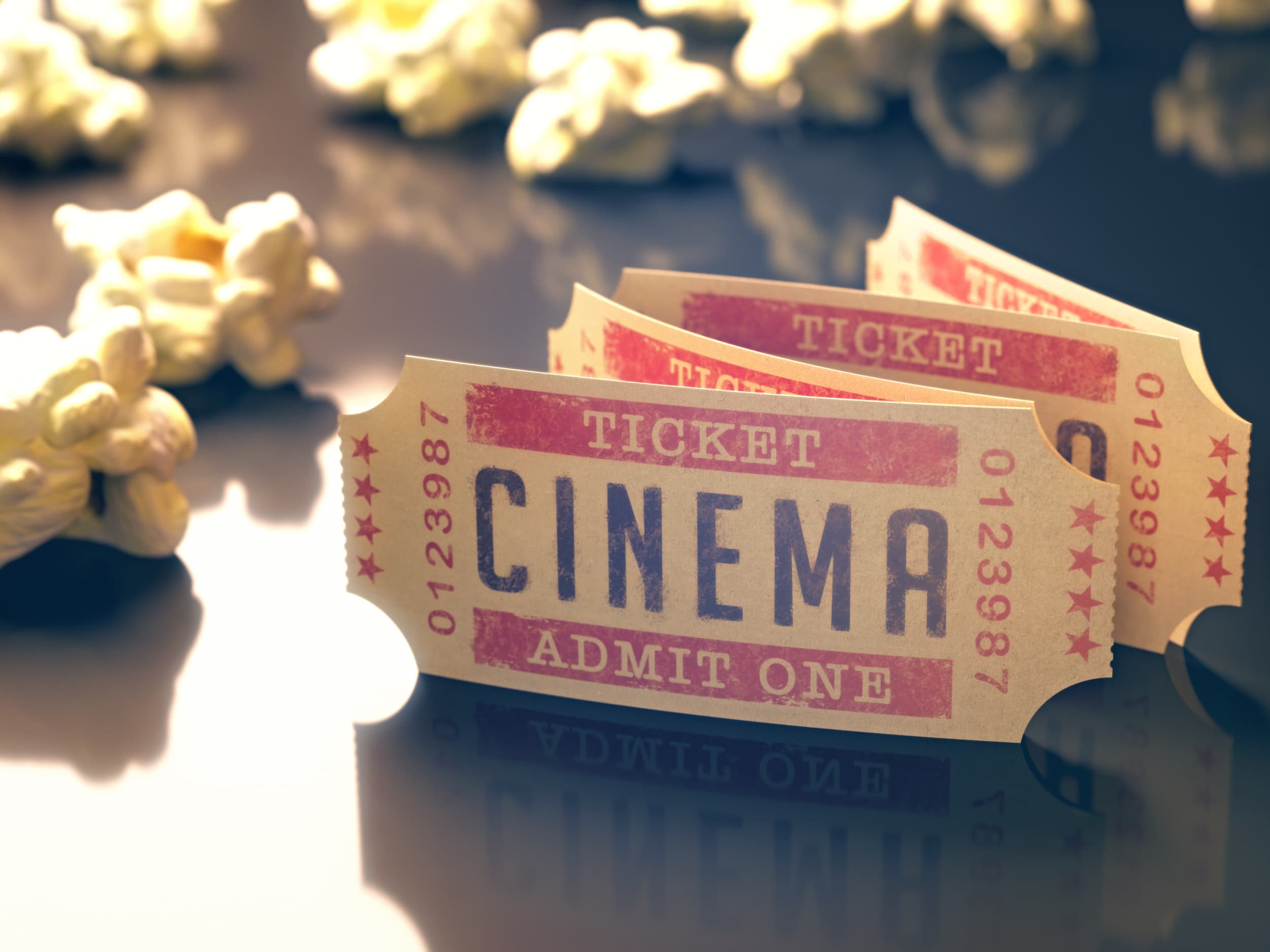 Entry ticket to the cinema with popcorn around. Clipping path included.