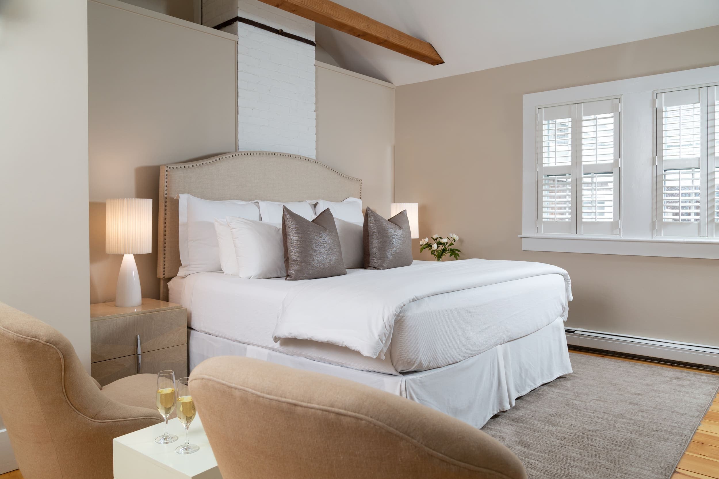 A large bed and lounge are in Room 18 at Chatham Inn