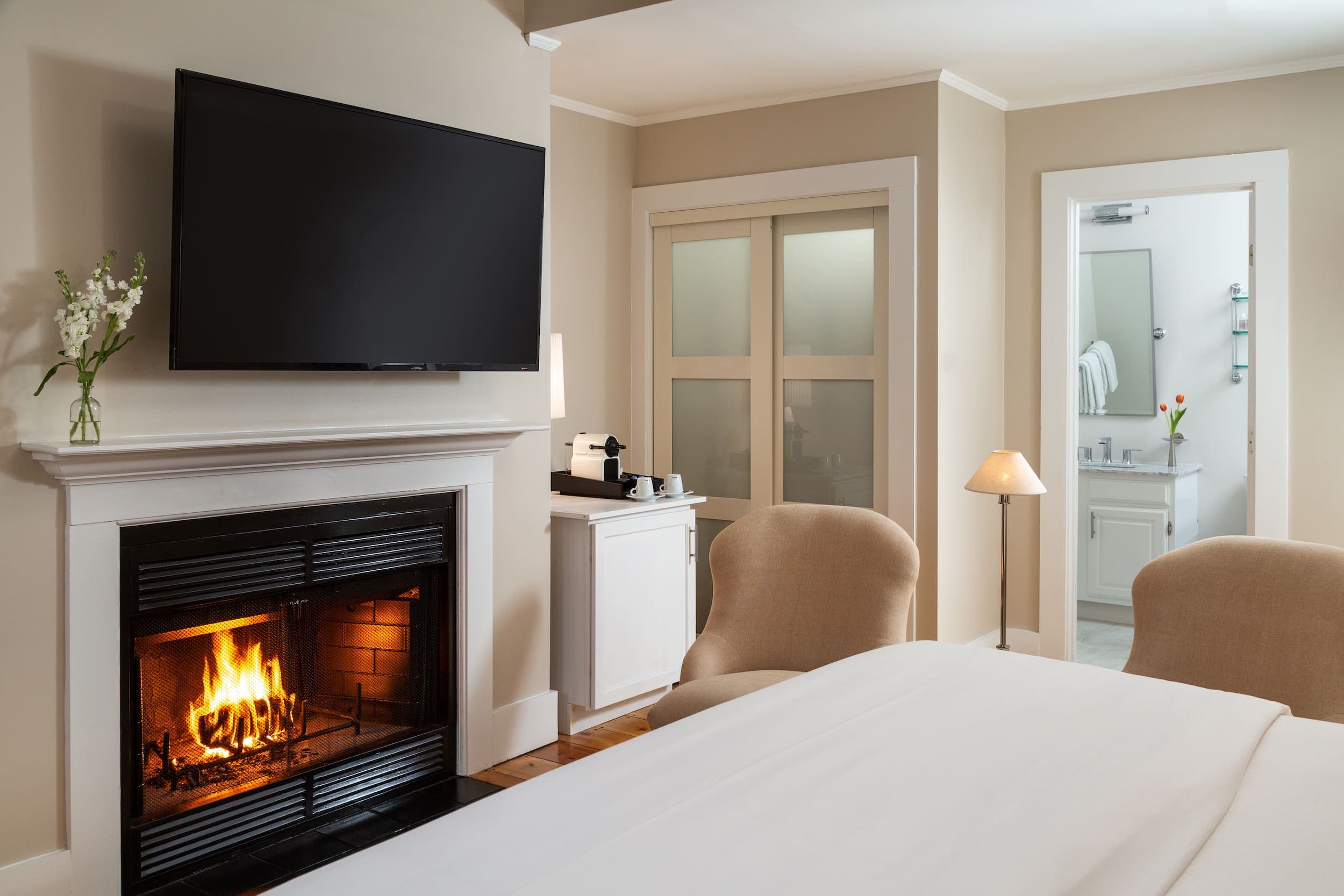 Chatham Inn Room 18 with a fireplace, large TV, and lounge chairs