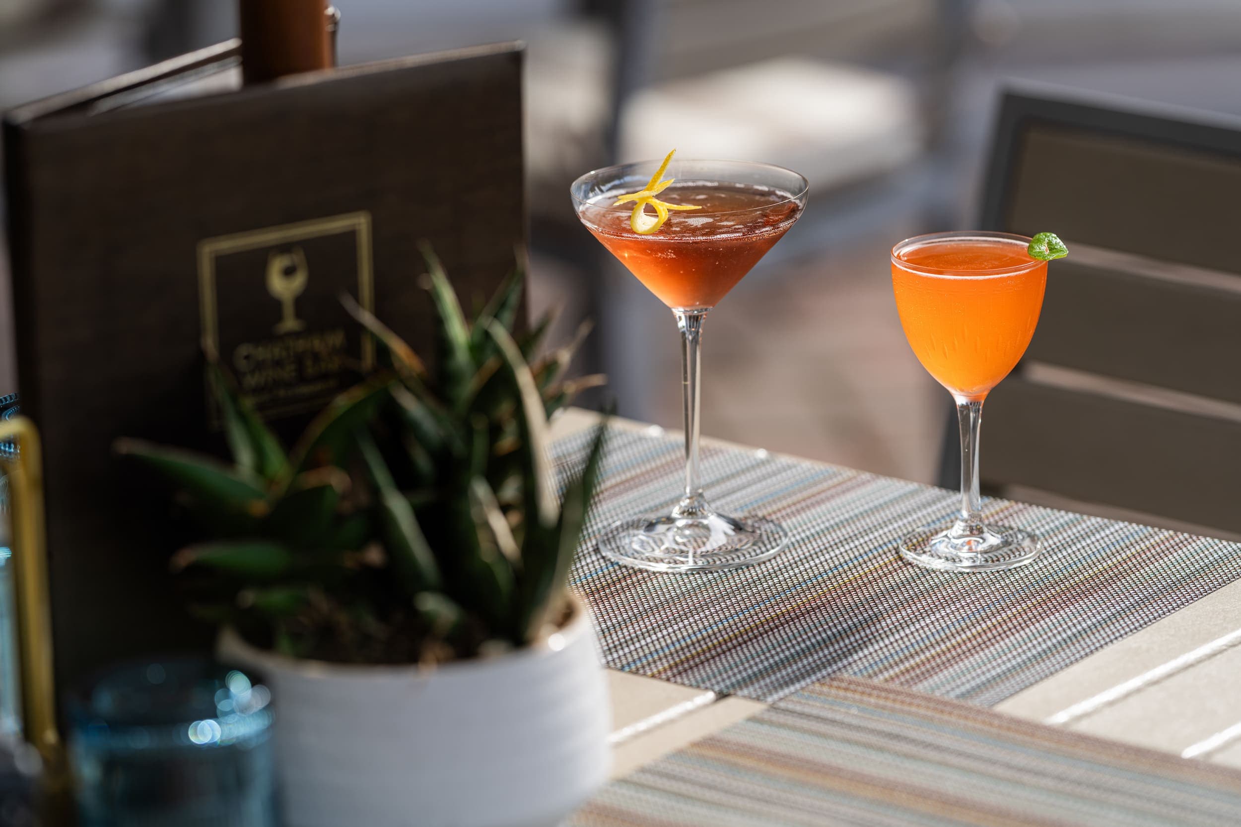 Two beautiful cocktails on a patio table at Chatham