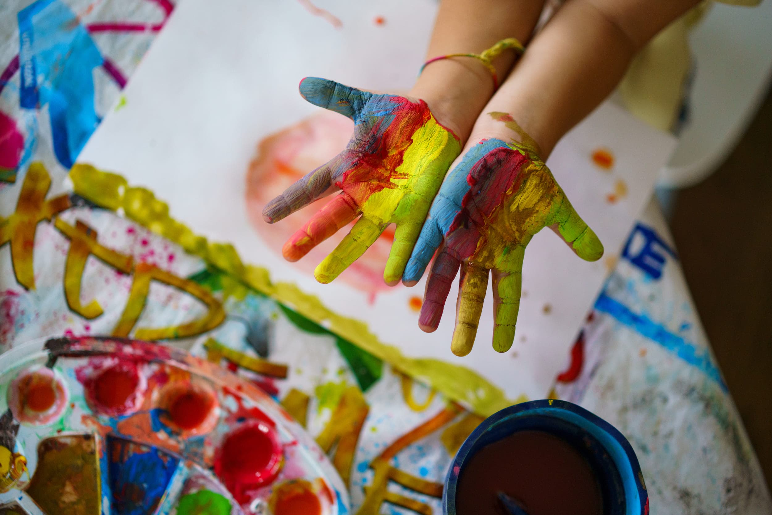 A child's hands full of paint at Hands On The Art Festivals In Eastham