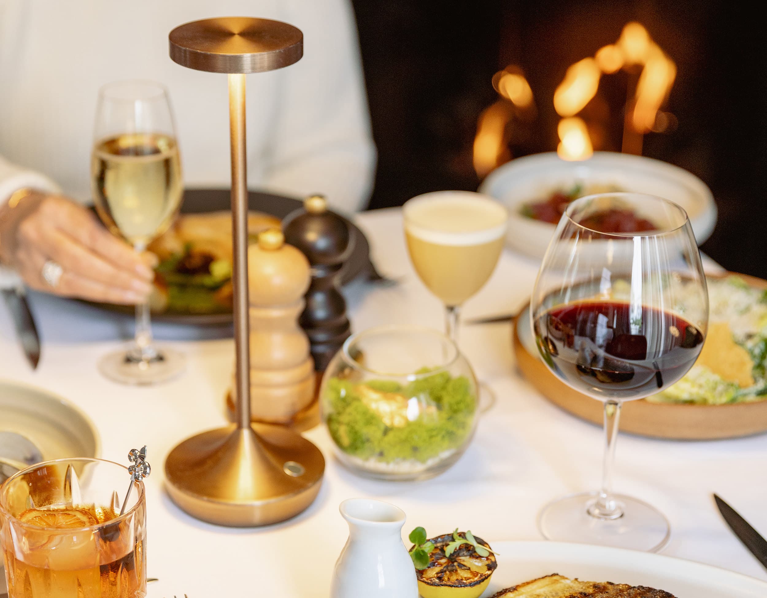 Fireside dining with wine and cocktails at Chatham Inn, Cape Cod.