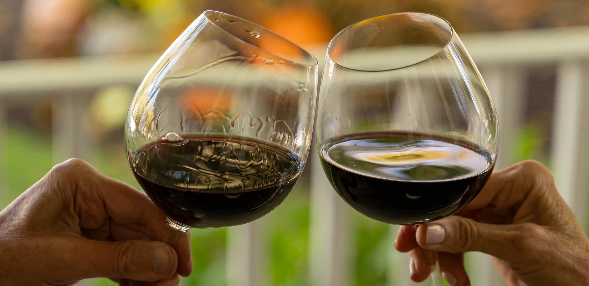 Guests toasting with red wine at sunset at Chatham Inn on Cape Cod.